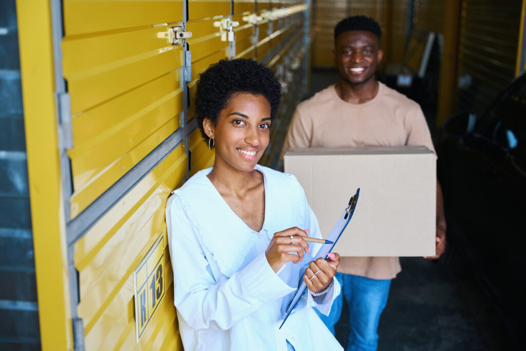 female self storage manager training an male employee